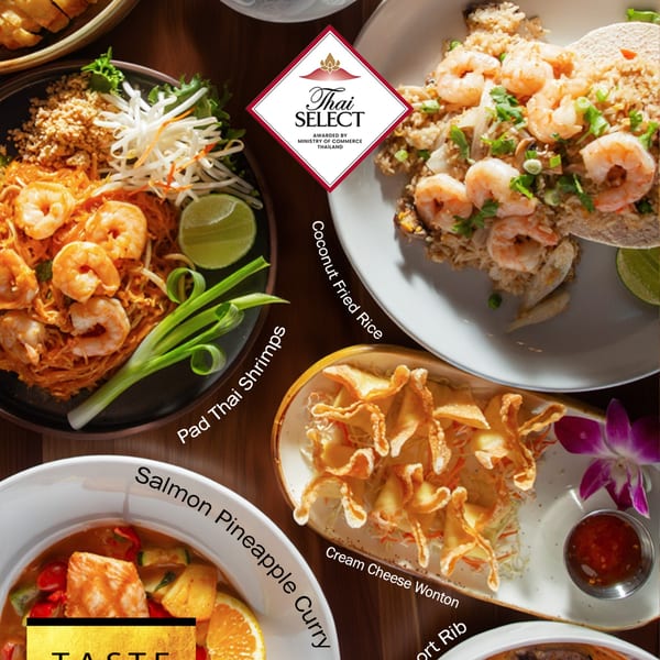 A top-down view of various Asian fusion dishes, including Pad Thai, fried rice, wontons, and curry.