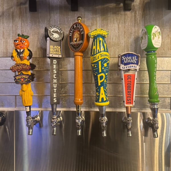 Six colorful beer taps with various brand handles, including Lost Coast, Deschutes, Mac & Jack's, Sierra Nevada, Samuel Adams, and Fremont.