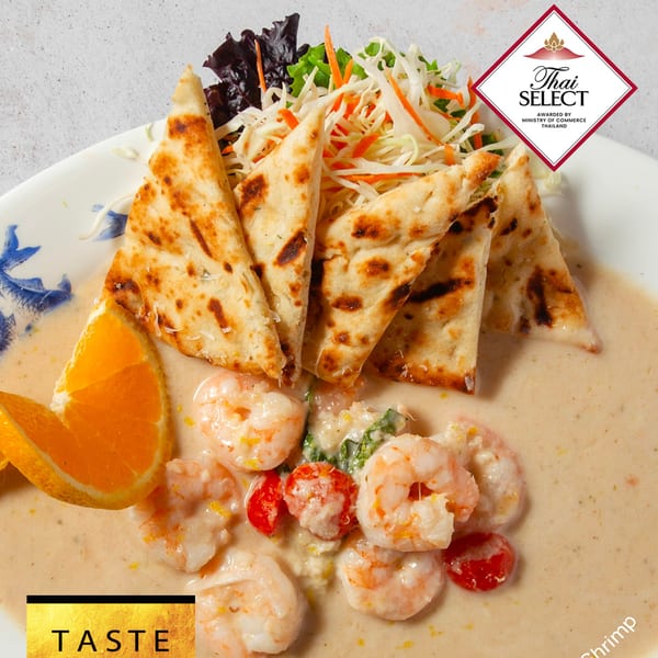 Taste Asian Fusion Bistro's creamy shrimp dish with naan bread, salad, and orange slices.